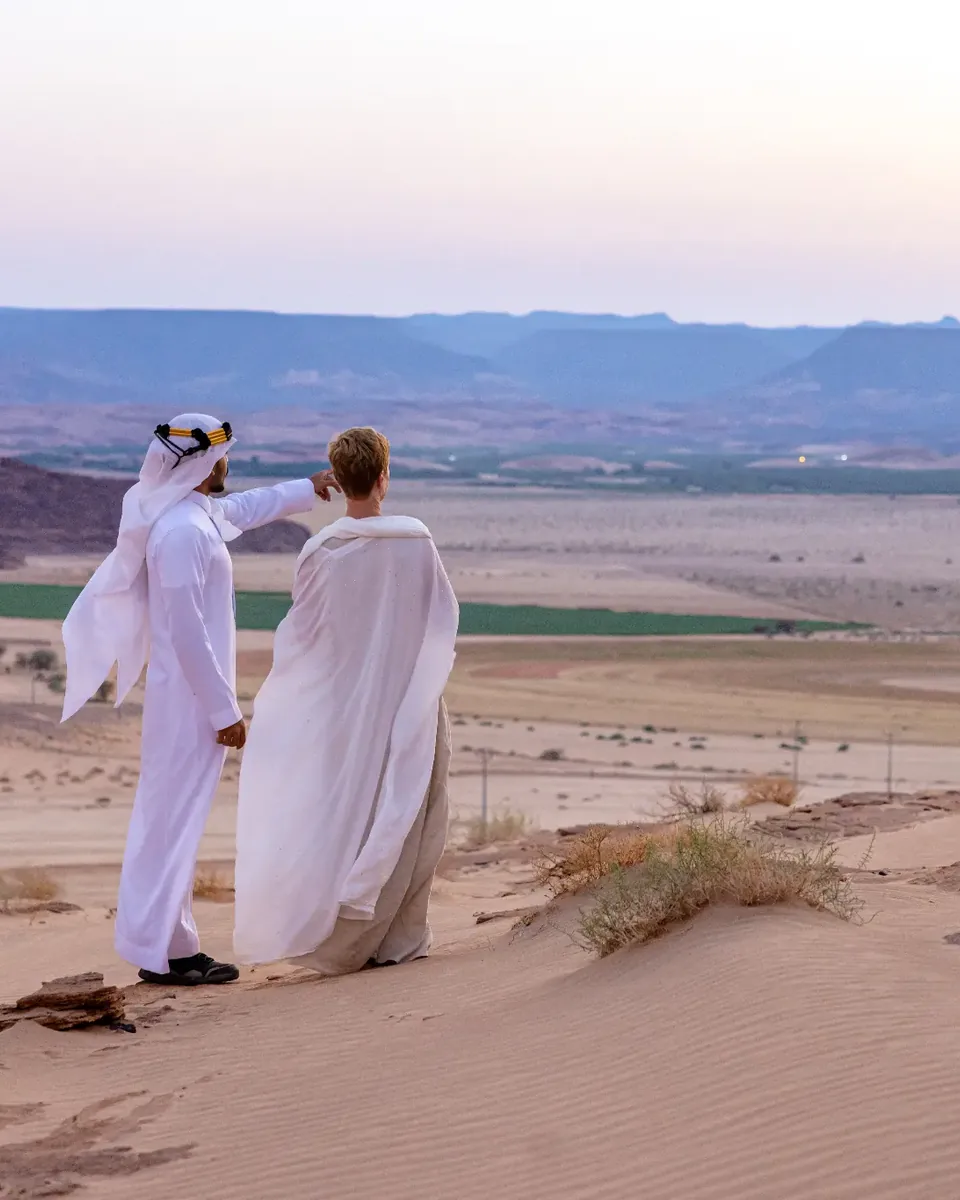 Abdullah sharing AlUla with a guest overlooking the valley