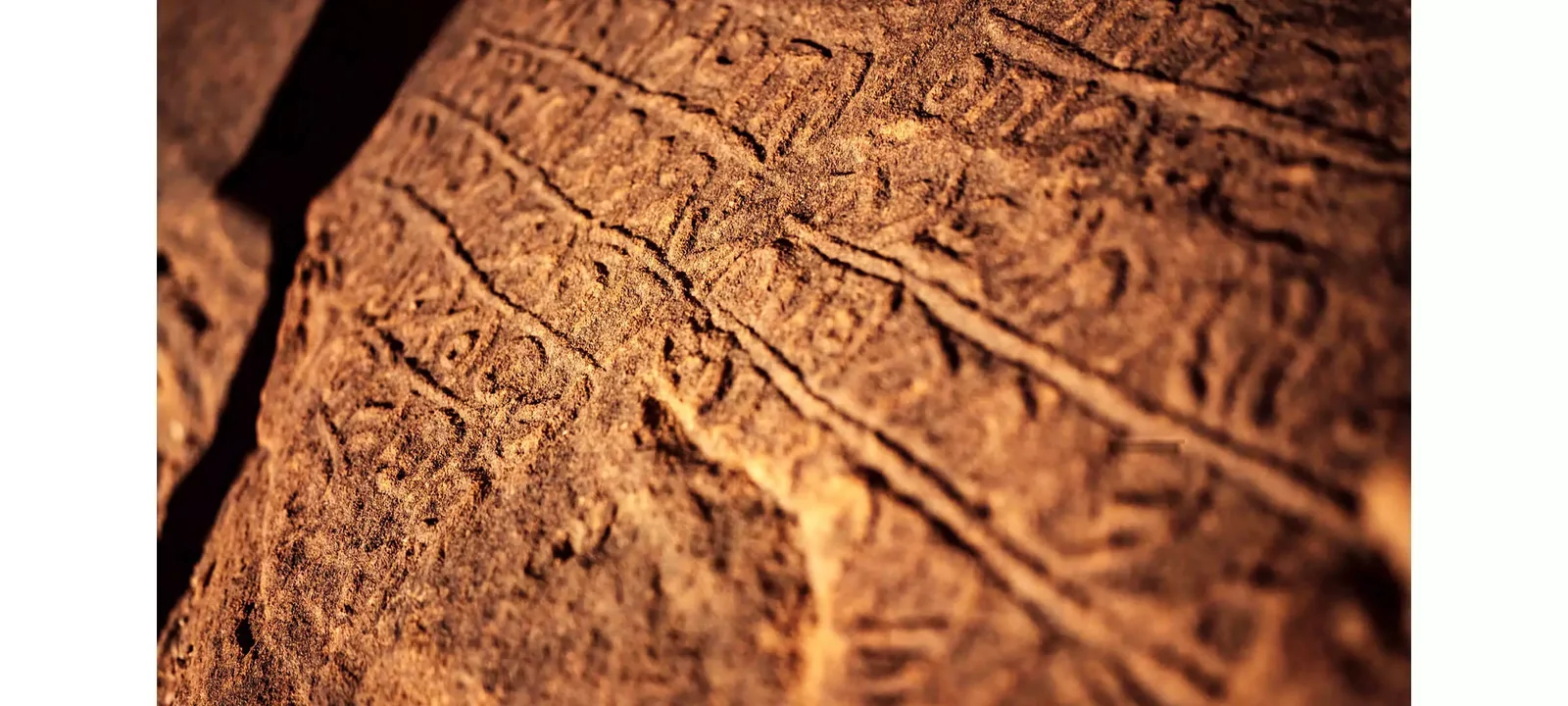 Detailed ancient inscriptions carved into sandstone at Jabal Ikmah