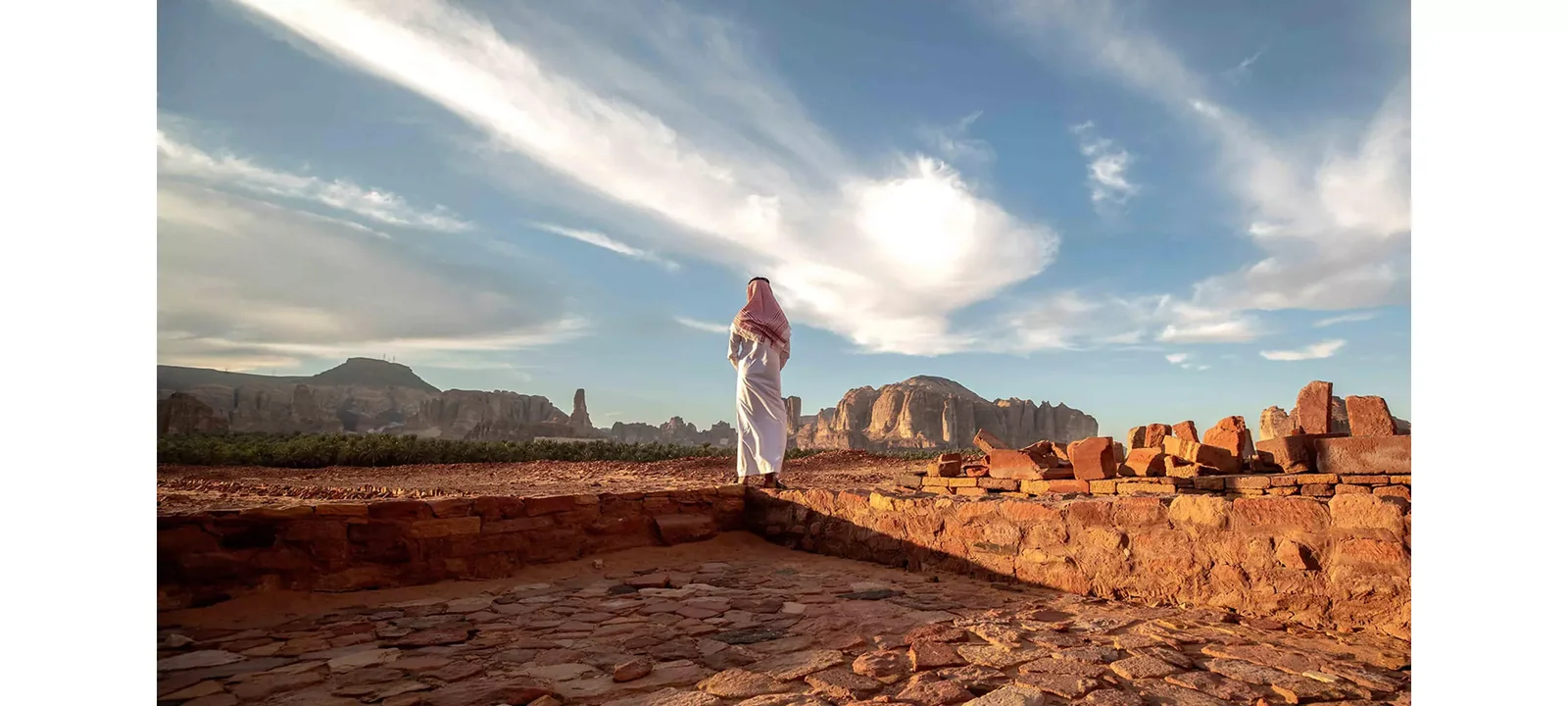 Visitor overlooking the archaeological landscape of Dadan in AlUla