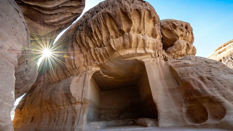 Rock-cut chamber and sandstone formation at Hegra in AlUla