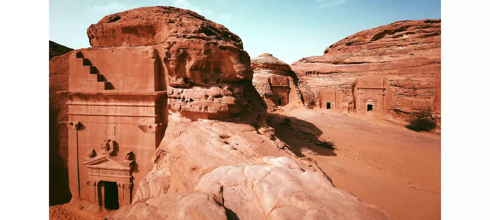 Wide view of the sandstone tomb landscape at Hegra