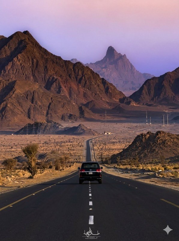 A desert road through AlUla's sandstone landscape