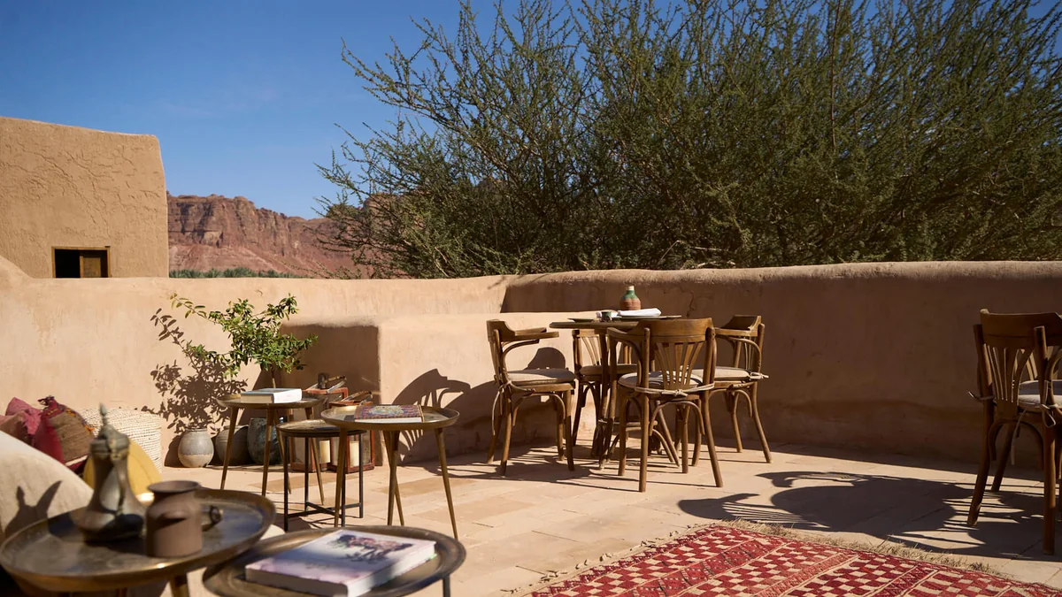 Outdoor coffee setting in AlUla near historic mudbrick architecture