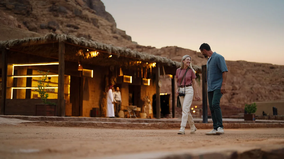 Visitors walking and talking in AlUla’s historic setting